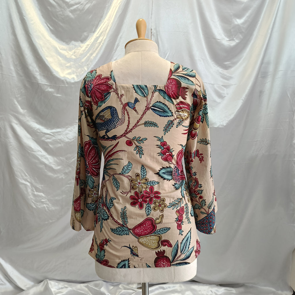 Mannequin wearing a floral embroidered dress against a white background