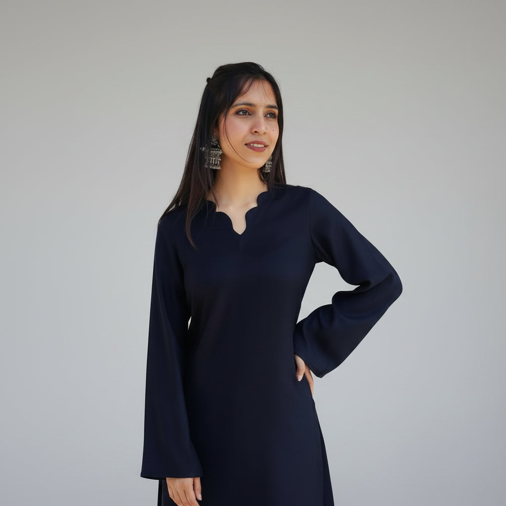 Woman wearing a black kurti with a scalped V-neckline 